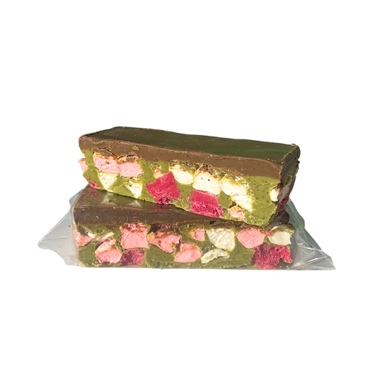 Two layered chocolate bar with visible nuts and pink candy on a white background
