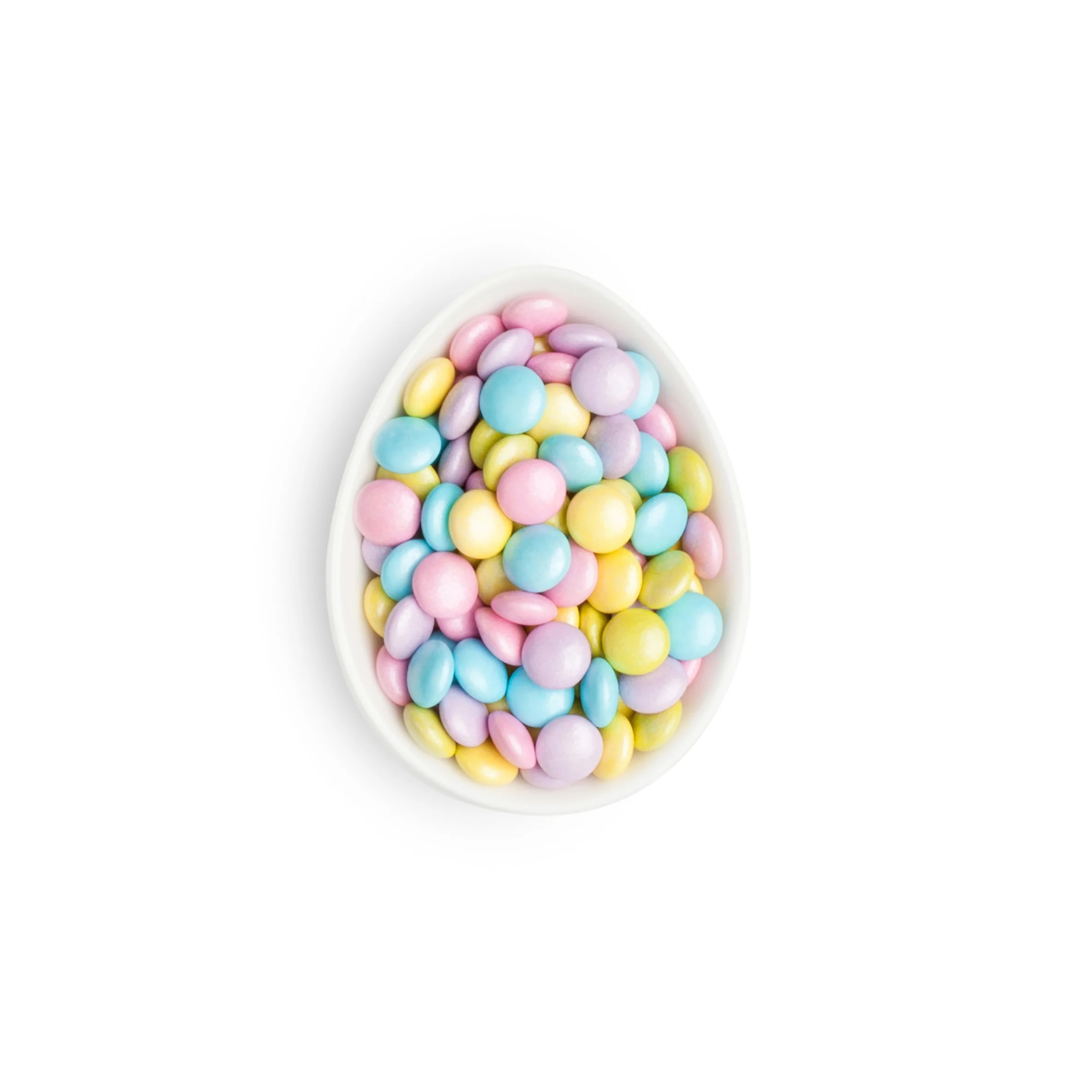Decorative bowl filled with pastel-colored candies on a white background