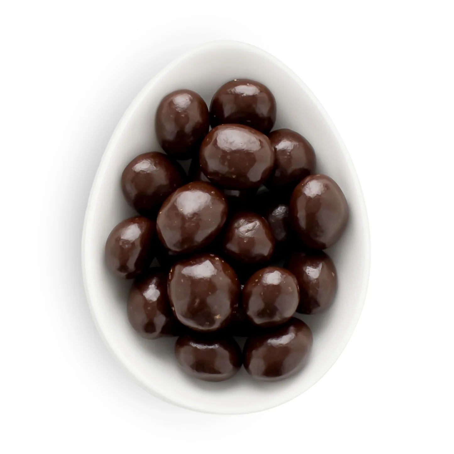 White bowl filled with chocolate-covered candies on a white background
