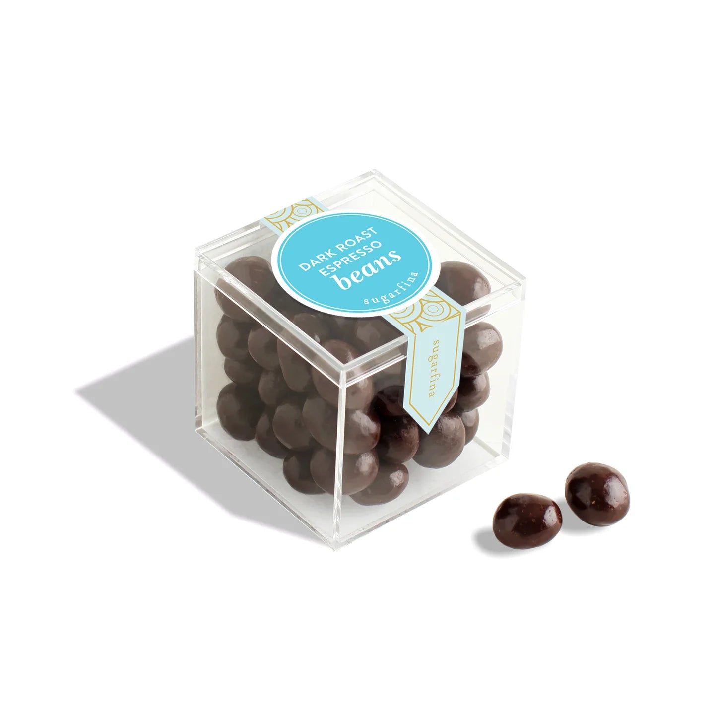 Clear cube container with dark chocolate beans and a blue label on a white background