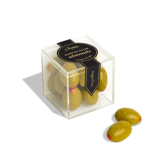 Box of chocolate covered almonds in the shape of olives with a label on a white background 