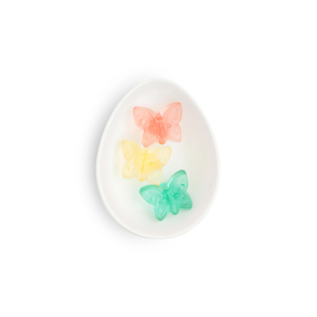 Round white plate with colorful butterfly designs on a white background