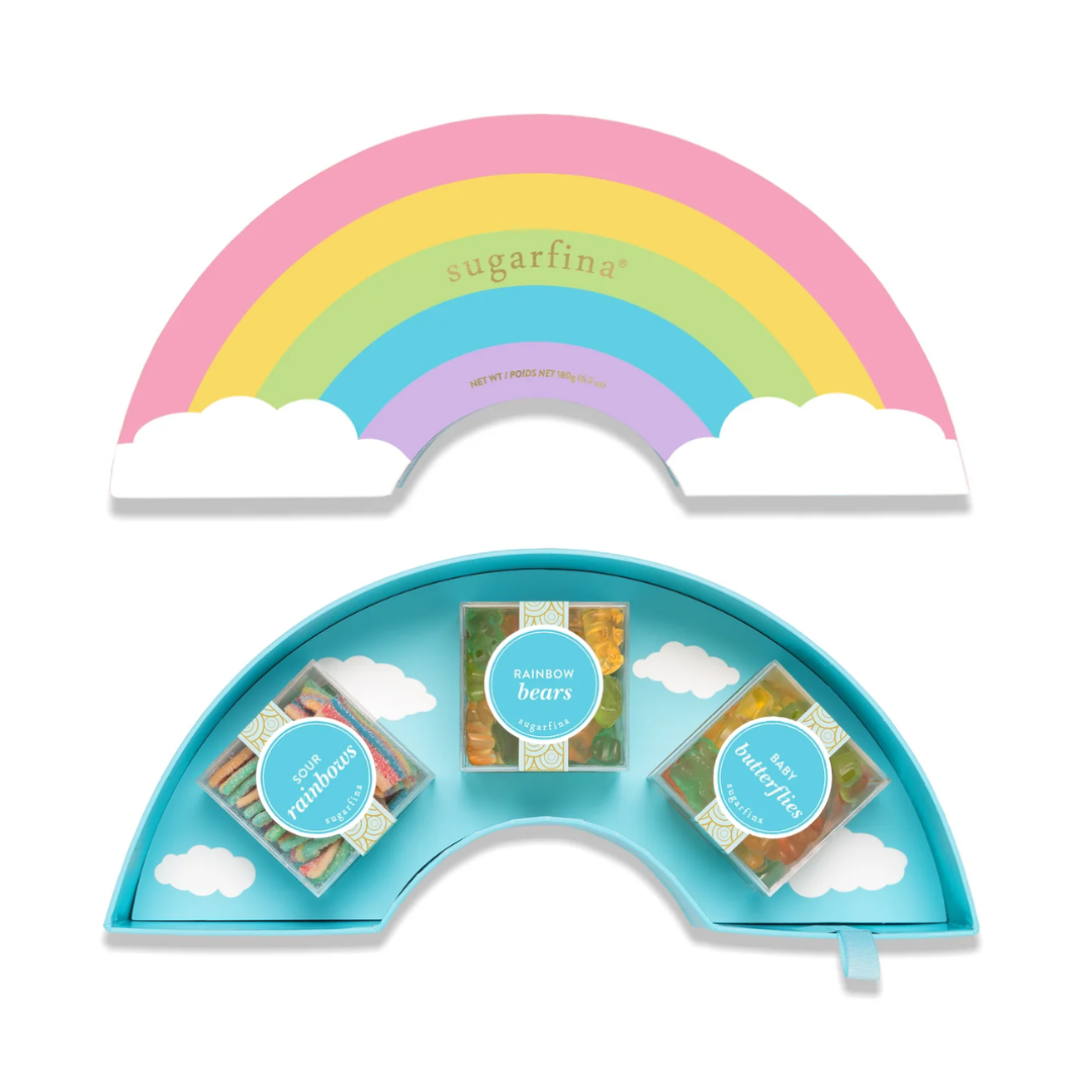 Sugarpina rainbow-shaped candy tray with colorful candy packages on a white background