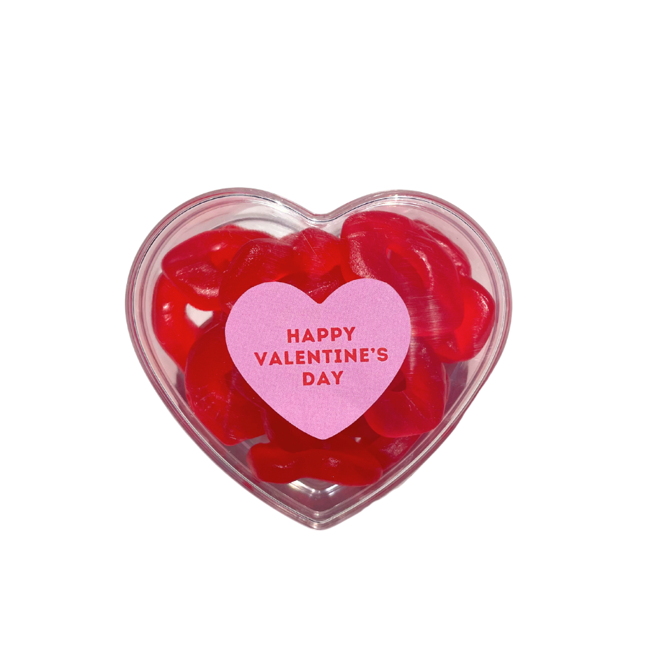 Heart-shaped container of red gummy bears with a pink 'Happy Valentine's Day' heart on a white background